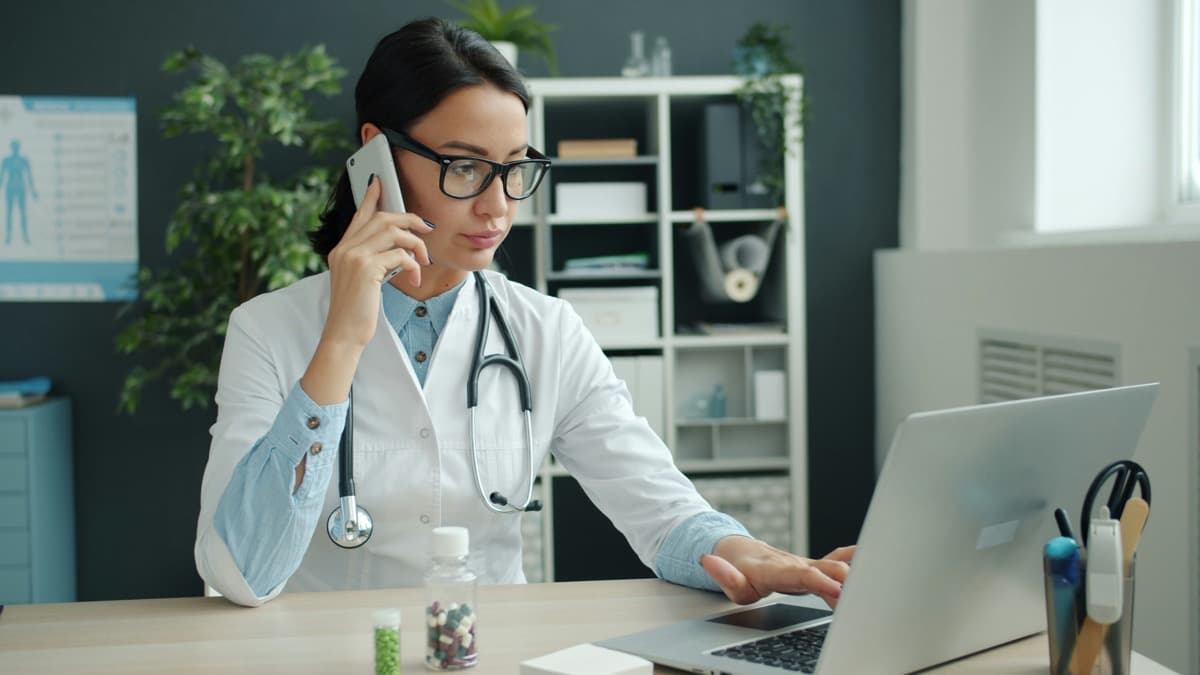 Médecin répondant au téléphone dans son cabinet